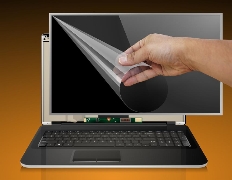 A laptop display with a transparent film being peeled from the screen.
